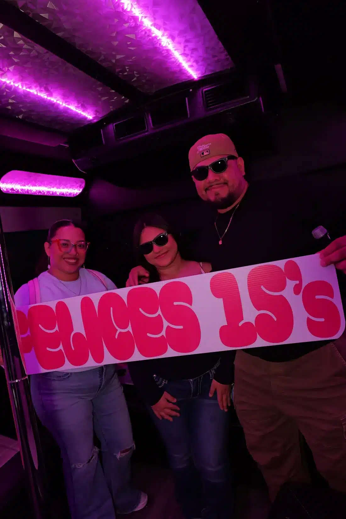 Quinceañera court celebrating inside the party bus