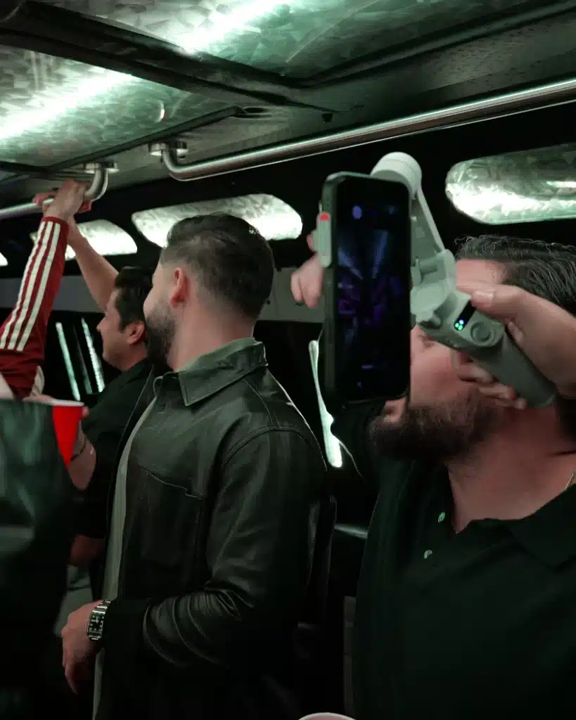 Group of friends dancing and celebrating inside a Luxus party bus