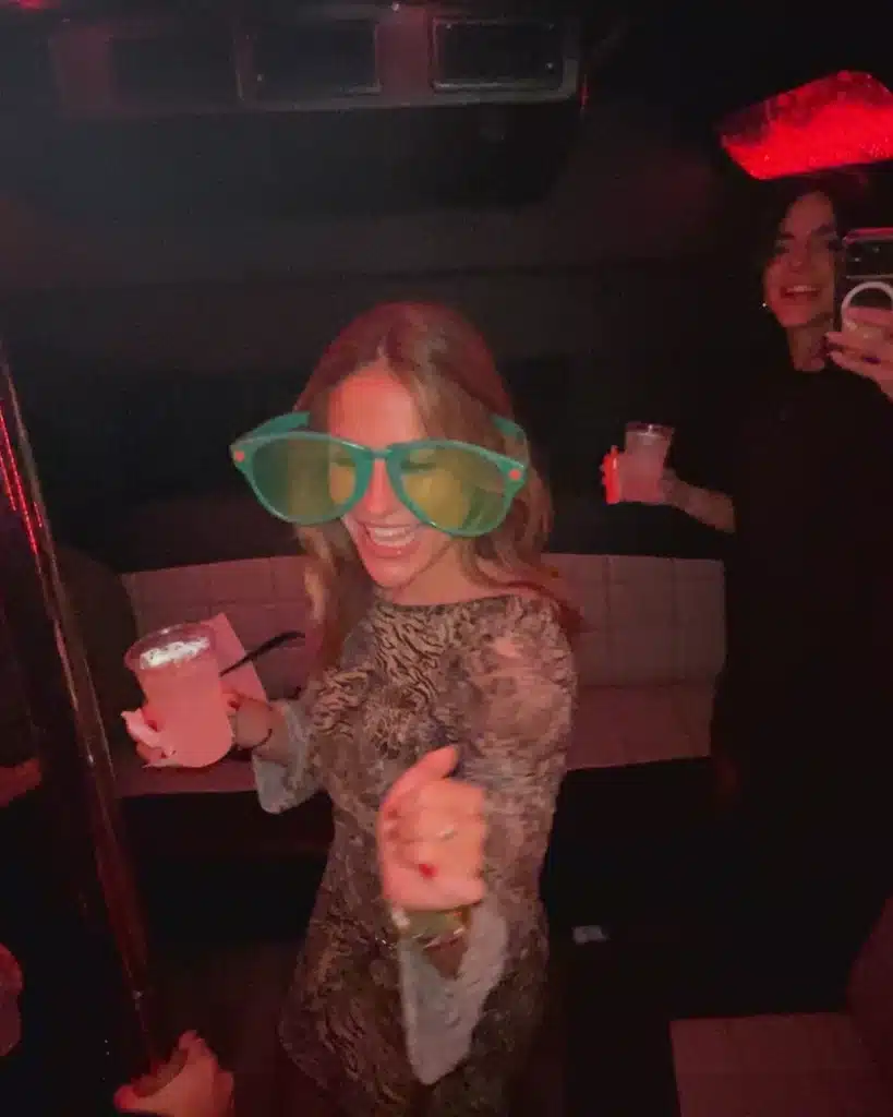 Passengers dancing inside a Luxus party bus with red LED lighting