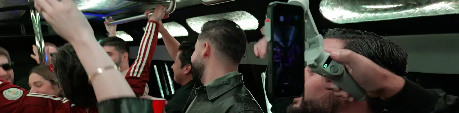 Group of friends dancing and celebrating inside a Luxus party bus