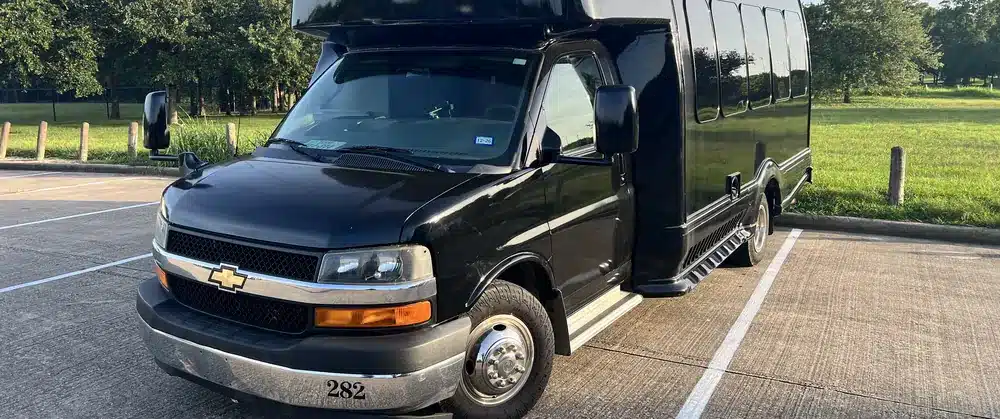 Front view of a black Luxus party bus with Chevrolet grille in Houston